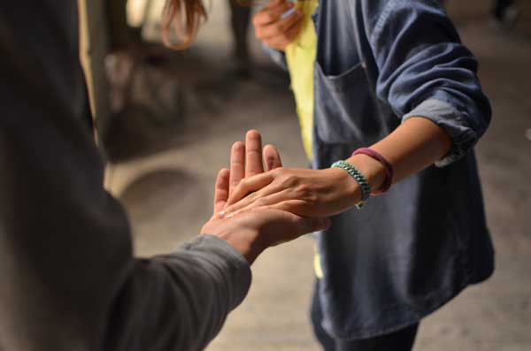 two people reaching out in solidarity